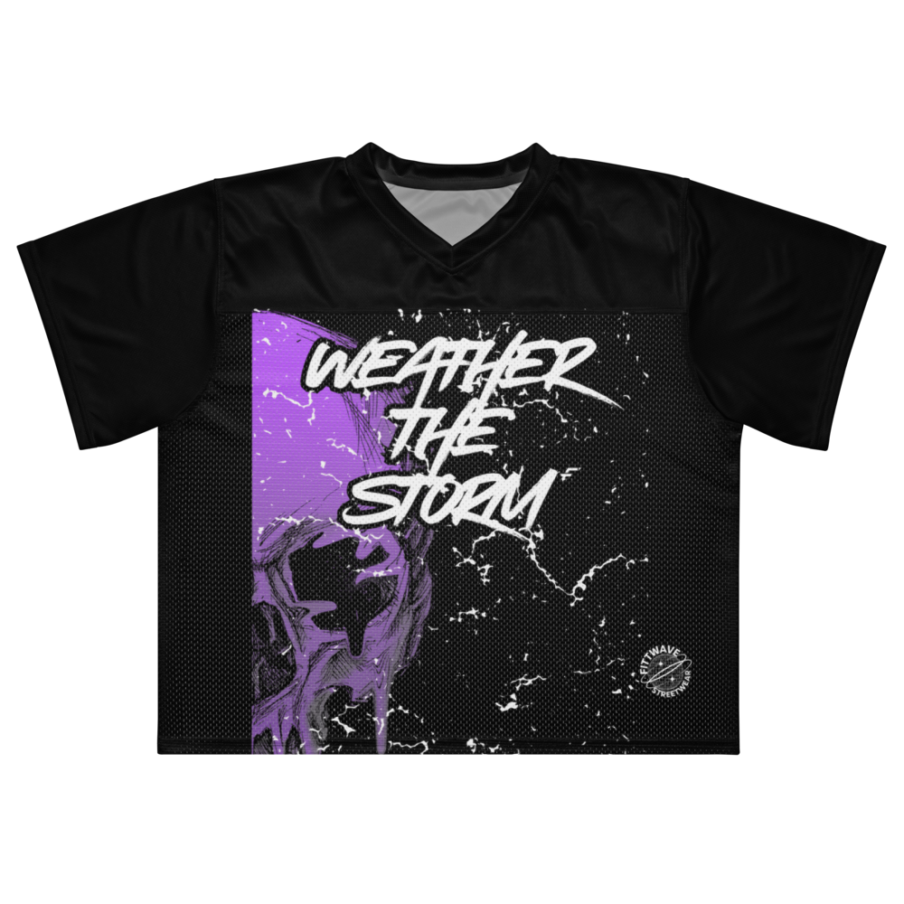 A black short-sleeve V-neck athletic Fittwave street weaejersey with a large front graphic featuring a purple distressed background, a dark skull illustration, and the text 'WEATHER THE STORM' in white. A small circular logo is visible near the lower right front. Made for skatewear, casual wear, and athletic wear. 